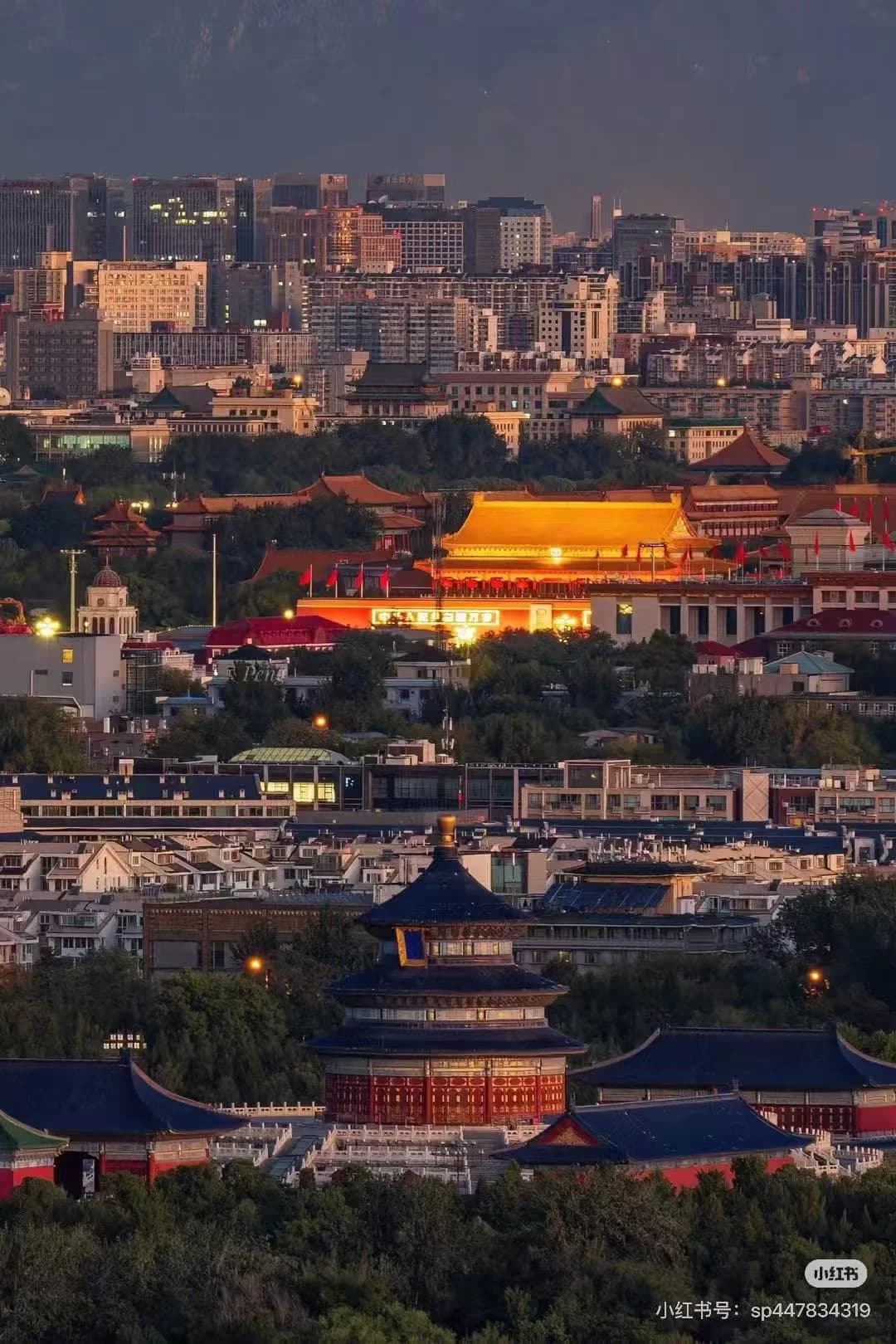 View of the Hall of Prayer for Good Harvests at the Temple of Heaven in the foreground, with the Forbidden City and modern skyscrapers in the distance.