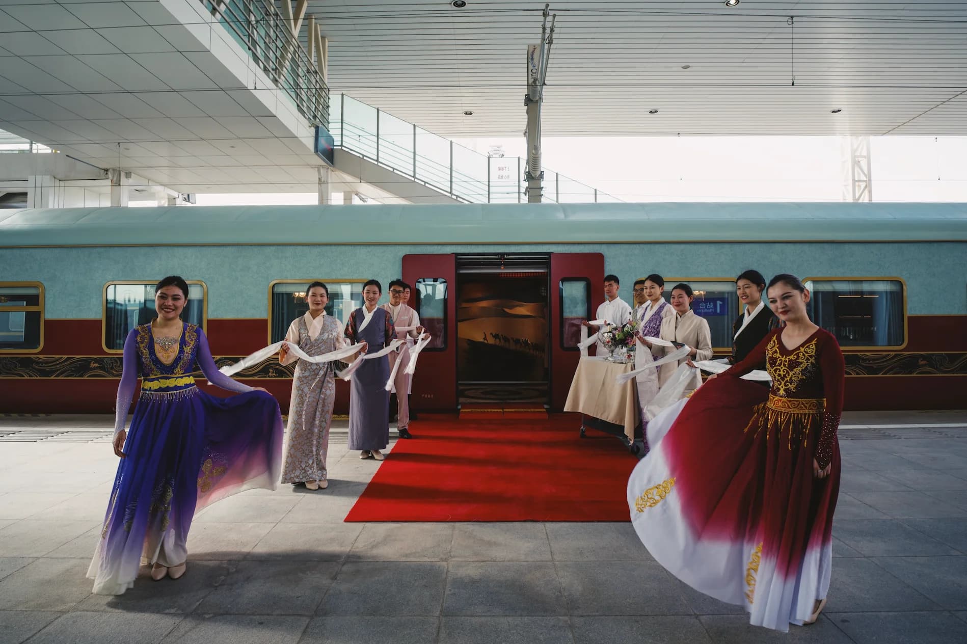 A premium tourist train runs between the Gobi and grasslands, with wide-open northwestern scenery outside the windows.